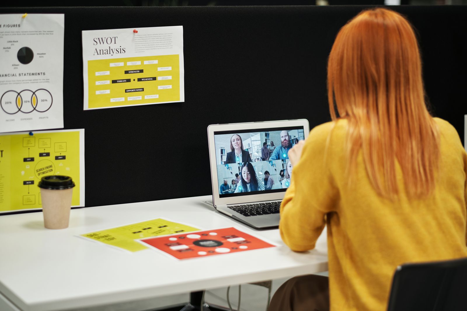 Coach leading a virtual strategy session from an organized workspace