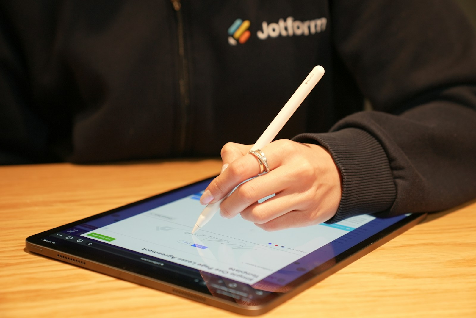 Customer signing a digital form on a tablet
